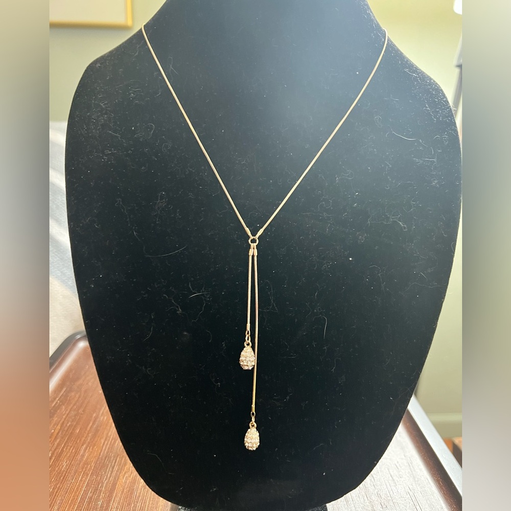 Gold tone necklace with Y or lariat design and two rhinestone balls to each end.